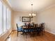 Dining room with hardwood floors, wainscoting, plantation shutters, and a stylish chandelier at 1755 Presidents Dr, Lawrenceville, GA 30043
