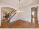 Formal dining room with hardwood floors, decorative molding, chandelier, and access to the staircase at 1755 Presidents Dr, Lawrenceville, GA 30043