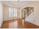 Formal dining room with hardwood floors, decorative molding, chandelier, and a large window with shutters at 1755 Presidents Dr, Lawrenceville, GA 30043