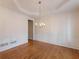 Formal dining room with hardwood floors, decorative molding, and a stylish chandelier at 1755 Presidents Dr, Lawrenceville, GA 30043