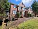 Beautiful two-story brick home with dark shutters and a well-maintained front yard and landscaping at 1755 Presidents Dr, Lawrenceville, GA 30043