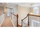 Upstairs hallway with wood railing overlooks the foyer; view of chandelier at 1755 Presidents Dr, Lawrenceville, GA 30043