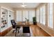 Bright home office with custom built-ins, plantation shutters, and a large executive desk at 1755 Presidents Dr, Lawrenceville, GA 30043
