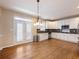 Bright eat-in kitchen featuring white cabinets, granite countertops, and hardwood floors with French door access at 1755 Presidents Dr, Lawrenceville, GA 30043