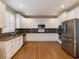 Kitchen featuring white cabinets, granite counters, stainless appliances and hardwood floors at 1755 Presidents Dr, Lawrenceville, GA 30043