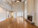 Spacious living room with a stone fireplace, high ceilings, and hardwood floors at 1755 Presidents Dr, Lawrenceville, GA 30043