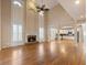 Open-concept living room featuring a fireplace, hardwood floors, and access to the kitchen at 1755 Presidents Dr, Lawrenceville, GA 30043