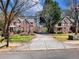 View of two homes with brick exteriors, well-manicured lawns, and driveways leading to the street at 1755 Presidents Dr, Lawrenceville, GA 30043