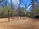 Neighborhood playground featuring swings with soft landing underneath surrounded by wooded area at 1755 Presidents Dr, Lawrenceville, GA 30043