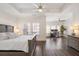 Bright main bedroom featuring a tray ceiling, hardwood floors, and a separate office area at 3632 Brookleigh Ln, Brookhaven, GA 30319