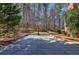 Outdoor basketball court nestled among mature trees, providing recreational space at 5327 Saville Nw Dr, Acworth, GA 30101
