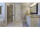 Bright bathroom featuring tile flooring, granite countertop, white cabinets, and a linen closet at 5327 Saville Nw Dr, Acworth, GA 30101