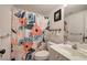 Well-lit bathroom featuring a floral shower curtain, white vanity, and coordinating fixtures at 5327 Saville Nw Dr, Acworth, GA 30101
