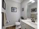Well-lit powder room with a modern vanity, mirror, and decorative artwork, offering a stylish and functional space at 5327 Saville Nw Dr, Acworth, GA 30101