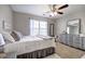 Well-lit bedroom featuring a ceiling fan, carpet, and a window with decorative curtains at 5327 Saville Nw Dr, Acworth, GA 30101