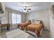 Bright bedroom featuring two twin beds with stylish decor and a ceiling fan at 5327 Saville Nw Dr, Acworth, GA 30101