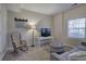 Cozy bonus room featuring neutral tones, a comfortable chair, and natural light from a large window at 5327 Saville Nw Dr, Acworth, GA 30101
