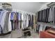 Organized walk-in closet with hanging racks, shelves, and shoe storage at 5327 Saville Nw Dr, Acworth, GA 30101