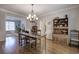 Dining room featuring hardwood floors, a chandelier, and adjacent rooms at 5327 Saville Nw Dr, Acworth, GA 30101