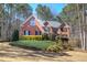 Charming two-story brick home with mature landscaping and a well-manicured front yard at 5327 Saville Nw Dr, Acworth, GA 30101