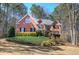 Charming two-story brick home with mature landscaping and a well-manicured front yard at 5327 Saville Nw Dr, Acworth, GA 30101