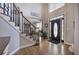 Bright foyer with hardwood floors, a staircase, and a decorative front door at 5327 Saville Nw Dr, Acworth, GA 30101