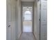 Hallway leading to a luxurious bathroom with natural light and white tile at 5327 Saville Nw Dr, Acworth, GA 30101