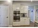 A modern kitchen showcasing stainless steel double ovens and sleek white cabinetry for a contemporary look at 5327 Saville Nw Dr, Acworth, GA 30101