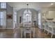 Kitchen and dining area with hardwood floors, lots of windows, and white cabinetry at 5327 Saville Nw Dr, Acworth, GA 30101
