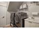 Functional laundry room with a washer, dryer, sink, and storage shelves, providing convenience and organization at 5327 Saville Nw Dr, Acworth, GA 30101