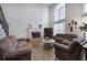 Spacious living room with a fireplace, hardwood floors, and comfortable seating, perfect for relaxing or entertaining at 5327 Saville Nw Dr, Acworth, GA 30101