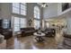Spacious living room with hardwood floors, tall windows, and an open view into the kitchen area at 5327 Saville Nw Dr, Acworth, GA 30101