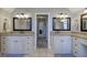 Elegant bathroom with dual sinks, granite countertops, white cabinetry and tile floors at 5327 Saville Nw Dr, Acworth, GA 30101