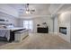 Spacious main bedroom with a fireplace, tray ceilings, a ceiling fan, and neutral decor at 5327 Saville Nw Dr, Acworth, GA 30101