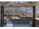Covered porch features bench seating and wooded views at 5327 Saville Nw Dr, Acworth, GA 30101
