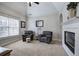 Comfortable sitting area with a tiled fireplace, natural light, and neutral decor at 5327 Saville Nw Dr, Acworth, GA 30101