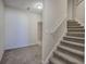 Carpeted staircase with neutral walls and white trim at 5327 Saville Nw Dr, Acworth, GA 30101