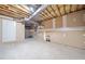 Unfinished basement area featuring concrete walls, concrete floor, exposed joists, ductwork and a white door at 540 Warrenton Dr, Douglasville, GA 30134