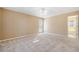 Bright bedroom with a ceiling fan and neutral walls, leading into the bathroom at 540 Warrenton Dr, Douglasville, GA 30134