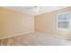 Bright bedroom features neutral carpet, walls, ceiling fan and natural light from a window at 540 Warrenton Dr, Douglasville, GA 30134