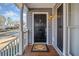 Covered front porch with dark-stained front door, creating an inviting entry at 540 Warrenton Dr, Douglasville, GA 30134