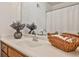 Bathroom with a large mirror, decorative vase, a white sink, and a basket of towels at 6035 Wintergreen Rd, Norcross, GA 30093