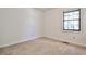 Smaller bedroom featuring neutral carpet, bright white walls, and natural light from one window at 6035 Wintergreen Rd, Norcross, GA 30093