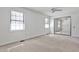 Bright bedroom features neutral carpet, ceiling fan, closet with mirror doors, and two windows at 6035 Wintergreen Rd, Norcross, GA 30093