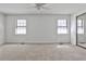 Spacious bedroom with neutral carpet, ceiling fan, and natural light from two windows at 6035 Wintergreen Rd, Norcross, GA 30093