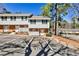 Inviting townhouse featuring a well-maintained facade, parking, and charming front entrances at 6035 Wintergreen Rd, Norcross, GA 30093