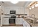 Well-lit kitchen featuring stainless steel appliances, granite countertops, and ample cabinet space at 6035 Wintergreen Rd, Norcross, GA 30093