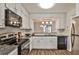 Modern kitchen with granite counters, stainless steel appliances, and a pass-through window to the living area at 6035 Wintergreen Rd, Norcross, GA 30093