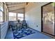 Screened in porch featuring blue painted floor and chairs, and lots of natural light at 6035 Wintergreen Rd, Norcross, GA 30093