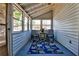 Comfortable sunroom featuring painted wood paneling, a vaulted ceiling, and a bright floral area rug at 6035 Wintergreen Rd, Norcross, GA 30093